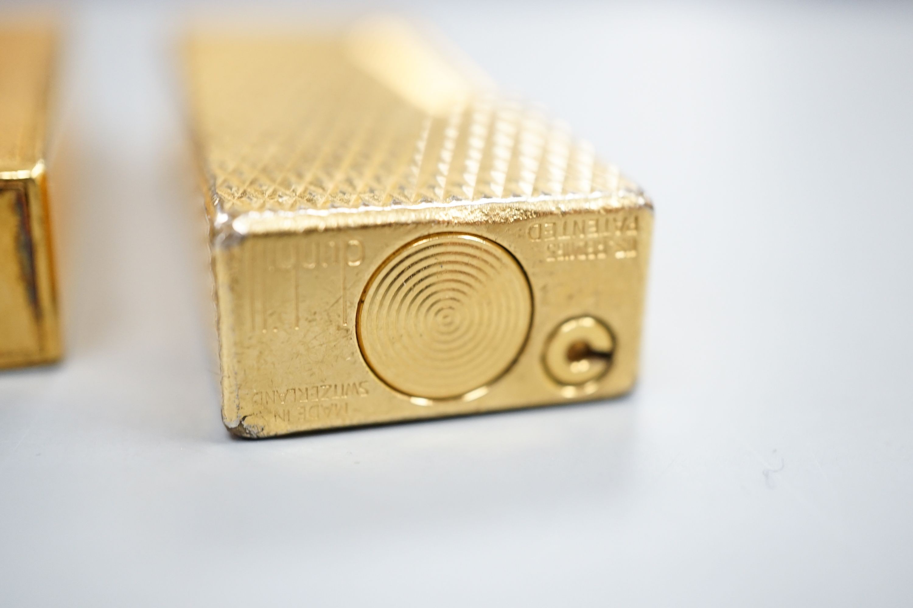 A gold plated Cartier lighter and a similar Dupont lighter